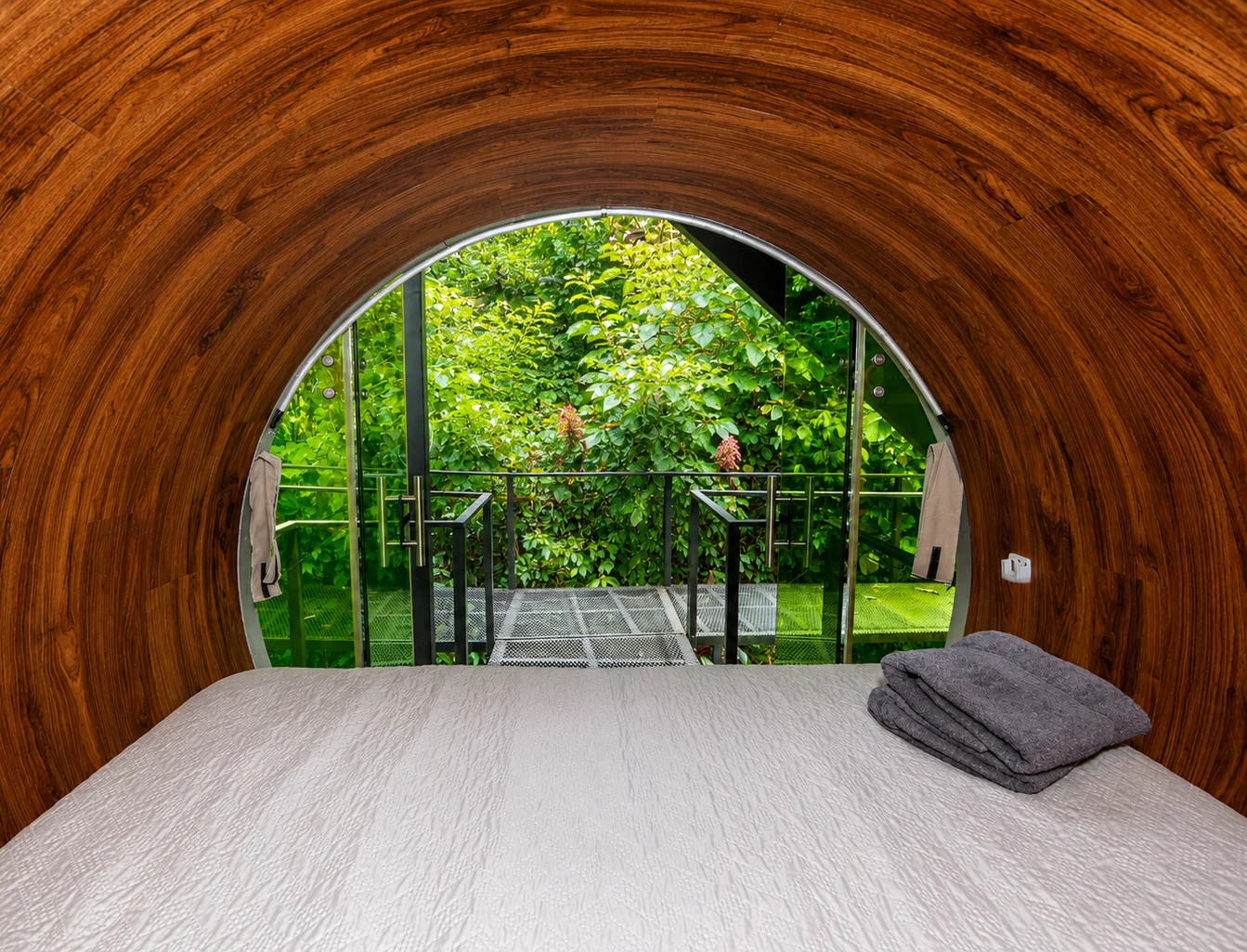 Inside a curved wooden room looking out to the garden