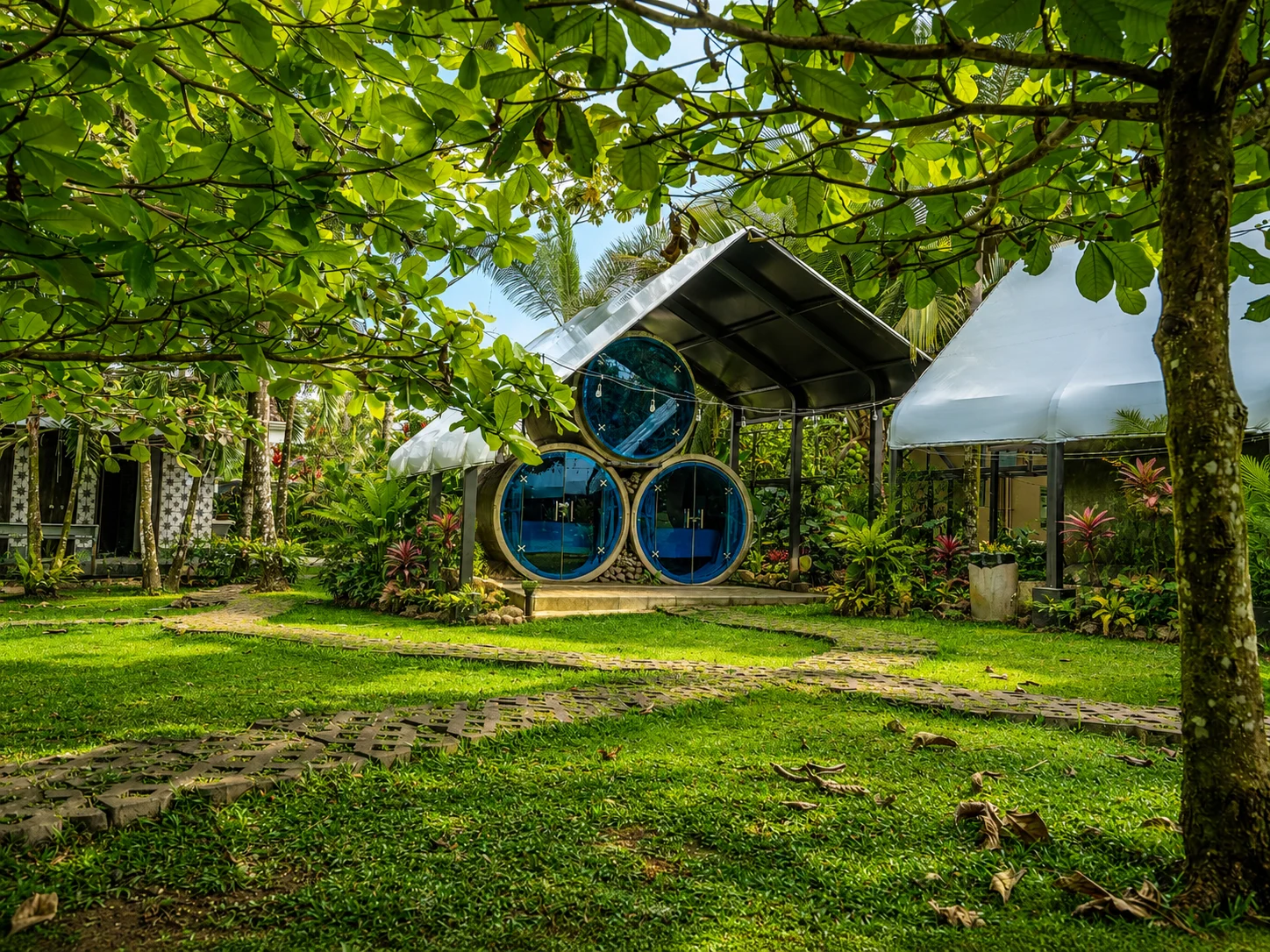 A secret garden of circular rooms framed by tropical leaves